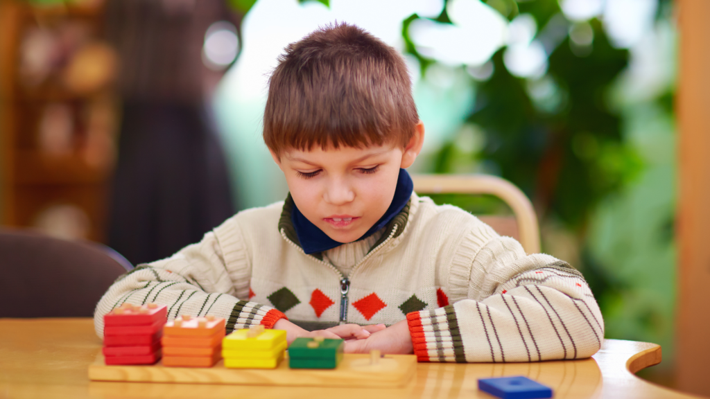 A dyslexic child focusing on a block while observing it closely.