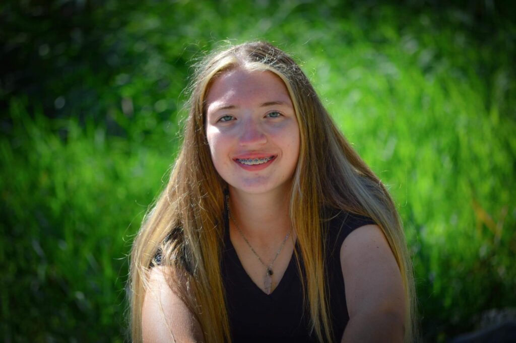 This image is of a girl who is 18 years old, She has blond hair.