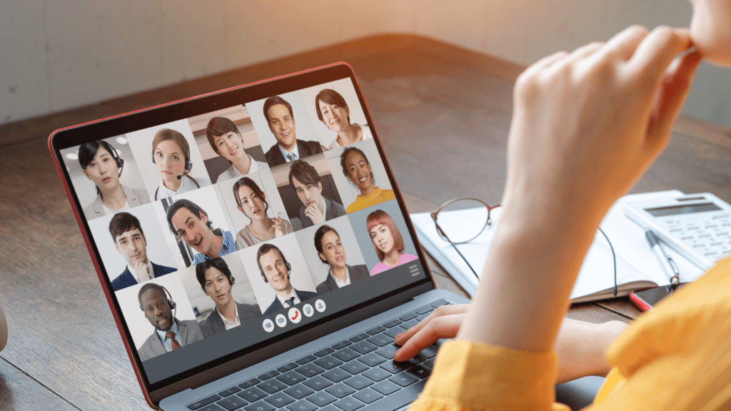 "Photo of a woman attentively participating in a Zoom meeting on her laptop, illustrating remote work and online collaboration.